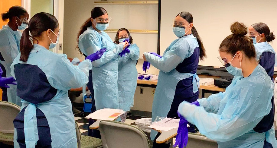 A Group Of Employees Standing In A Training Center